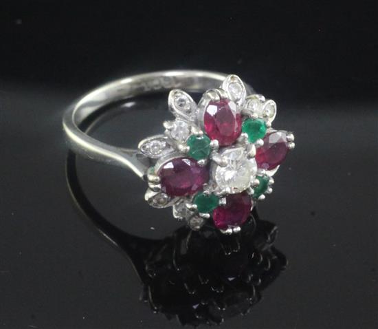 An 18ct white gold, ruby, emerald and diamond cluster ring, size L.